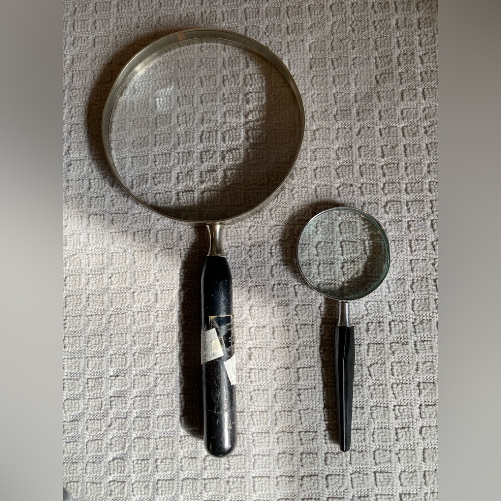 Pair of vintage handheld magnifying glasses. Good vintage condition.